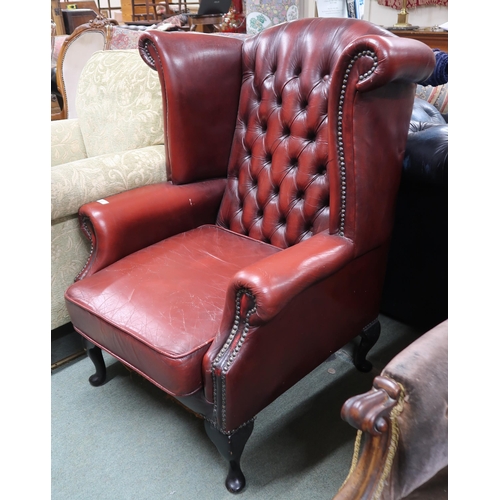 47 - A 20th century Chesterfield style leather button back upholstered armchair on cabriole supports, 104... 