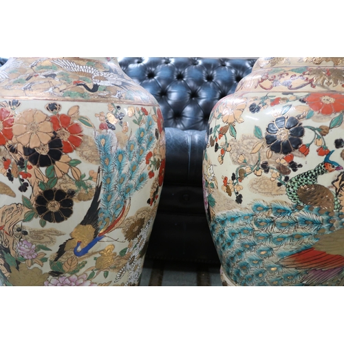 57 - A pair of large oriental vases depicting herons and peacocks, 81cm high (2) 