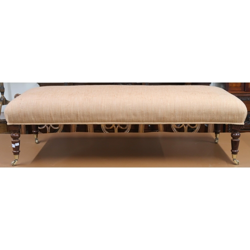 61 - A 20th century Ottoman footstool upholstered in terracotta fabric on turned supports terminating in ... 