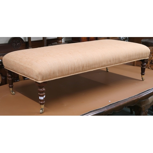 61 - A 20th century Ottoman footstool upholstered in terracotta fabric on turned supports terminating in ... 