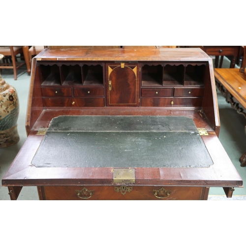 62 - A 19th century walnut veneered writing bureau with fall front fitted writing compartment over two sh... 