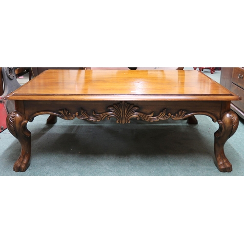 75 - A 20th century mahogany coffee table with rectangular top on hairy paw feet joined by carved friezes... 