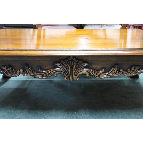 75 - A 20th century mahogany coffee table with rectangular top on hairy paw feet joined by carved friezes... 