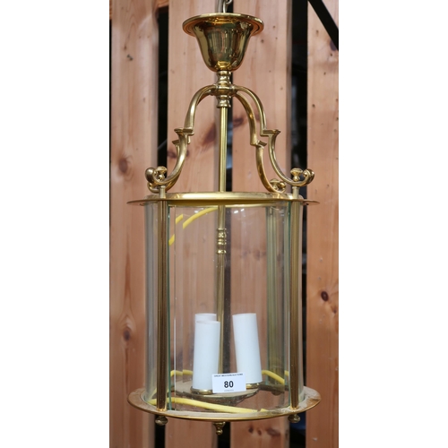 80 - A 20th brass hallway lantern with four serpentine arms over cylindrical glass shade, 52cm high x 25c... 