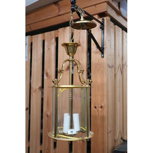 80 - A 20th brass hallway lantern with four serpentine arms over cylindrical glass shade, 52cm high x 25c... 