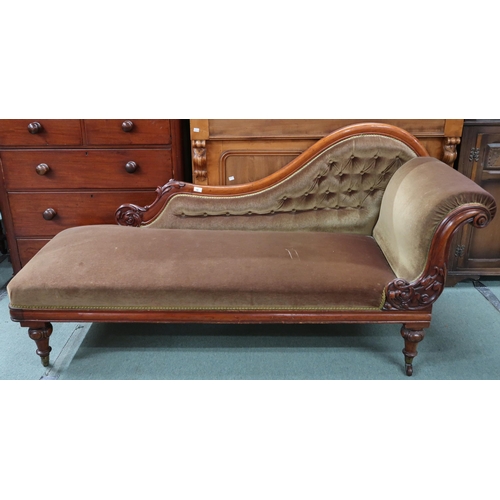 92 - A Victorian mahogany chaise longue with velvet upholstery on turned supports terminating in ceramic ... 