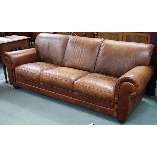 94 - A contemporary Italian leather upholstered three seater sofa on turn feet, 85cm high x 233cm wide x ... 