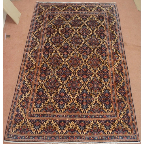 2133 - A DARK BLUE GROUND MOOD RUG with all-over medallion design and multiple coloured borders, 302cm long... 