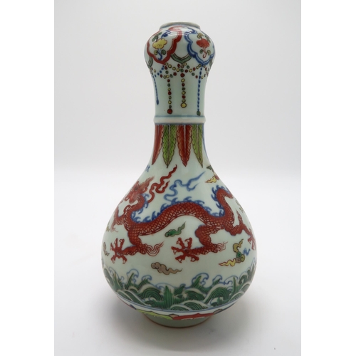 2367 - A CHINESE WUCAI GARLIC NECK VASEdecorated with dragons amongst clouds and waves chasing flaming pear... 