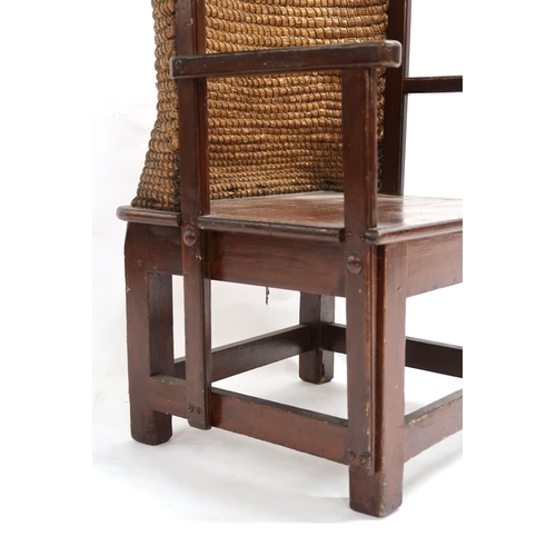 2016 - AN EARLY 20TH CENTURY STAINED BEECH ORKNEY CHAIR with rush back rest over straight arms over plain s... 