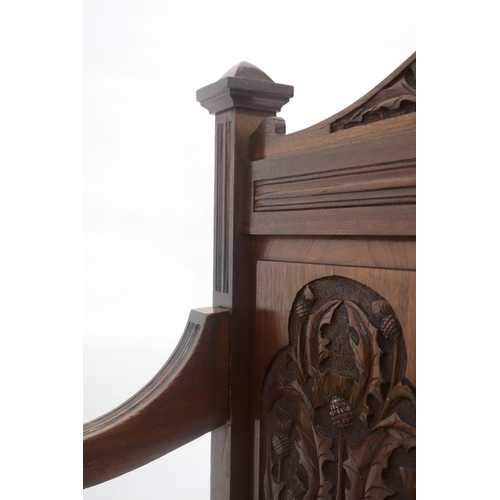 2019 - AN EARLY 20TH CENTURY SCOTTISH HALL SETTLE with three panel back rest carved with thistle motifs fla... 