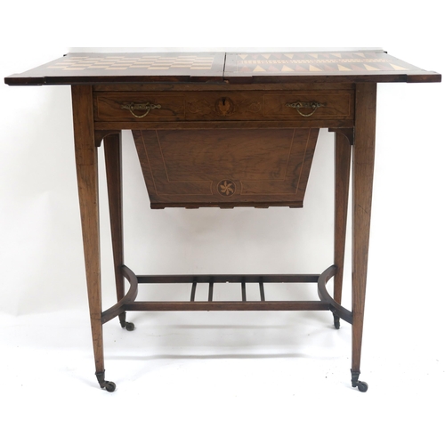 2028 - A VICTORIAN ROSEWOOD FOLD-OVER SEWING/GAMES TABLE with inlaid rectangular top with shaped corners wh... 