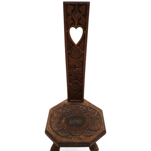 2033 - AN EARLY 20TH CENTURY CARVED OAK SPINNING CHAIR back rest pierced with heart shaped decoration over ... 