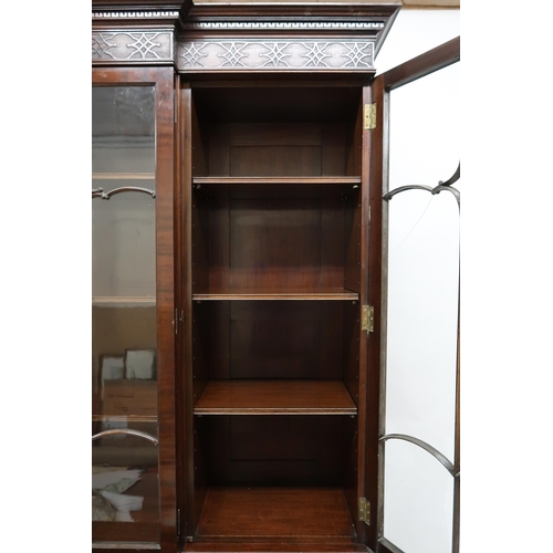 2035 - AN EARLY 20TH CENTURY MAHOGANY BREAKFRONT BOOKCASE with moulded cornice over pair of beaded glazed d... 