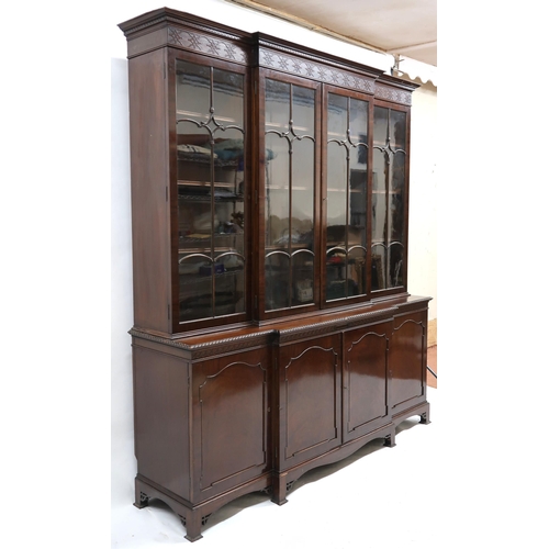 2035 - AN EARLY 20TH CENTURY MAHOGANY BREAKFRONT BOOKCASE with moulded cornice over pair of beaded glazed d... 
