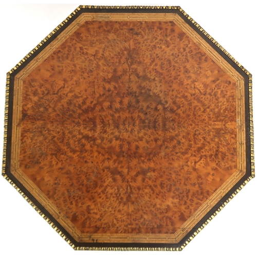 2044 - AN EARLY 20TH CENTURY CONTINENTAL BURR WALNUT VENEERED OCTAGONAL TWO TIER OCCASIONAL TABLE with bras... 