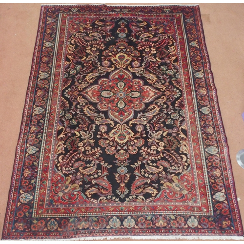 2131 - A BLACK FLORAL FOLIATE PATTERNED GROUND LILIHAN RUG with red central medallion, matching spandrels a... 