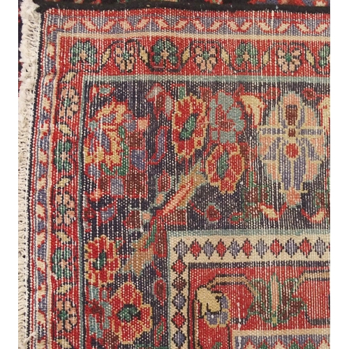 2131 - A BLACK FLORAL FOLIATE PATTERNED GROUND LILIHAN RUG with red central medallion, matching spandrels a... 