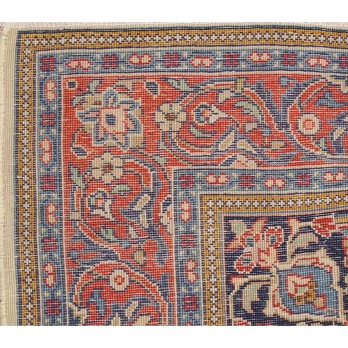 2132 - A CREAM FLORAL PATTERNED GROUND SAROUGH RUG with mustard central medallion, dark blue spandrels and ... 