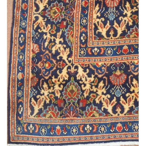 2133 - A DARK BLUE GROUND MOOD RUG with all-over medallion design and multiple coloured borders, 302cm long... 