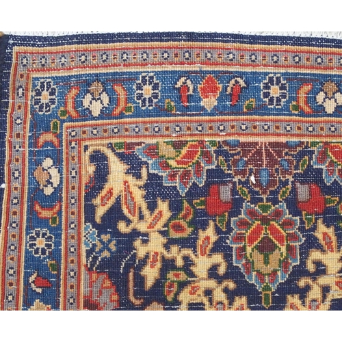 2133 - A DARK BLUE GROUND MOOD RUG with all-over medallion design and multiple coloured borders, 302cm long... 