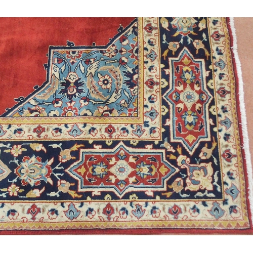 2134 - A RED GROUND TABRIZ RUG with dark blue central medallion, light blue spandrels and dark blue borders... 