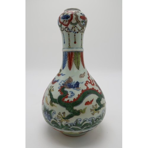 2367 - A CHINESE WUCAI GARLIC NECK VASEdecorated with dragons amongst clouds and waves chasing flaming pear... 