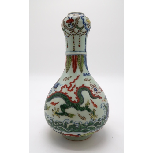 2367 - A CHINESE WUCAI GARLIC NECK VASEdecorated with dragons amongst clouds and waves chasing flaming pear... 