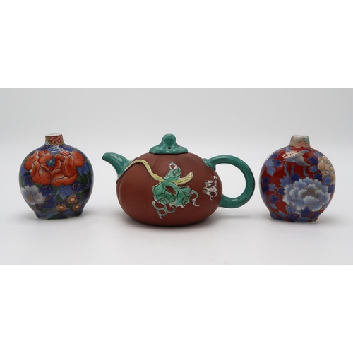 2370 - A CHINESE YIXING TEAPOTof gourd form, decorated and enamelled in relief with foliage and birds, 19.2... 