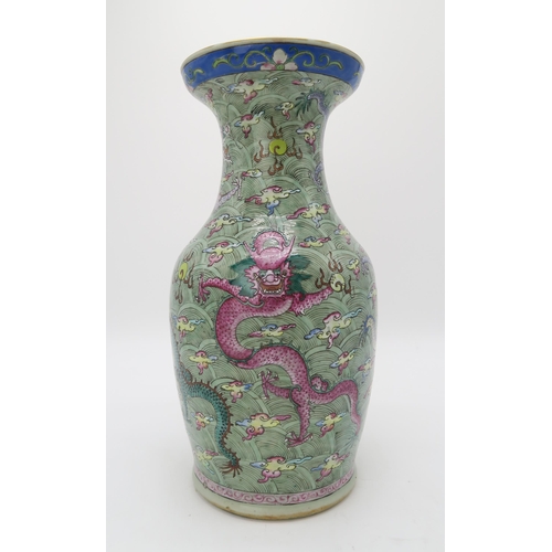 2374 - A CHINESE CELADON GROUND FAMILLE ROSE BALUSTER VASEdecorated with dragons amongst clouds and waves c... 