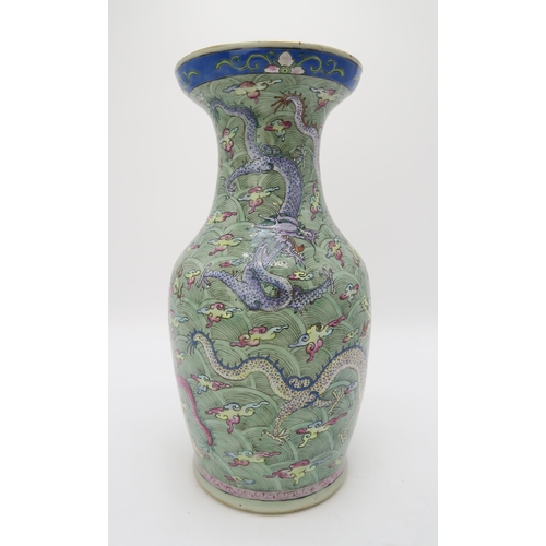 2374 - A CHINESE CELADON GROUND FAMILLE ROSE BALUSTER VASEdecorated with dragons amongst clouds and waves c... 