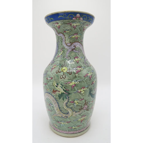 2374 - A CHINESE CELADON GROUND FAMILLE ROSE BALUSTER VASEdecorated with dragons amongst clouds and waves c... 