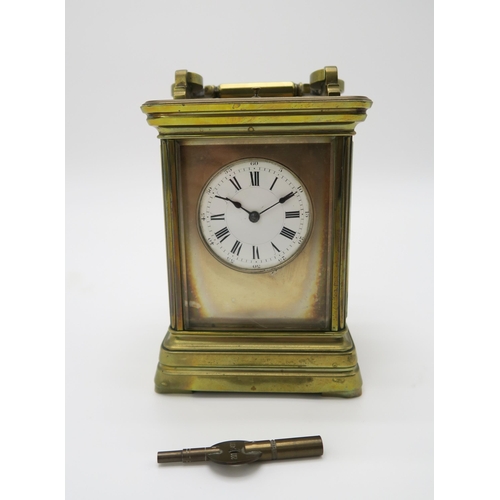 2153 - A LATE 19TH CENTURY GILT BRASS AND GLASS REPEATING CARRIAGE CLOCK the white dial with roman numerals... 