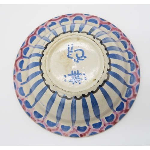 2168 - JESSIE MARION KING (SCOTTISH 1875-1949)A hand painted pottery bowl with geometric decoration in blac... 