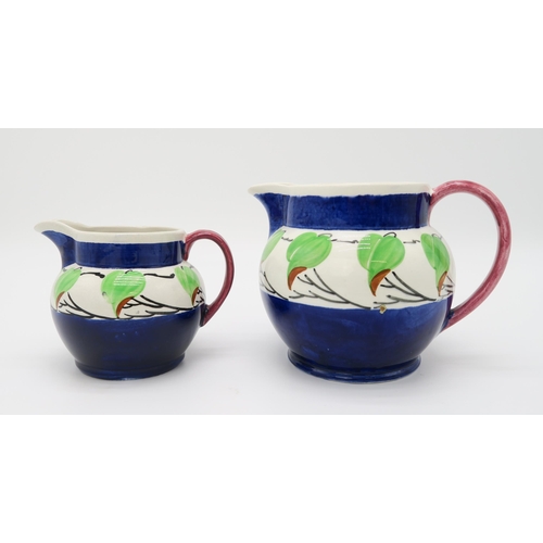 2169 - RICHARD AMOUR FOR BOUGH POTTERY Two graduated jugs, painted with leaves and blue banding, an apple p... 