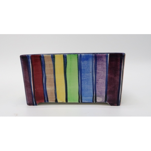 2181 - ELIZABETH MARY WATT (SCOTTISH 1886-1954)A rainbow stripe rectangular planter, a tea plate painted wi... 