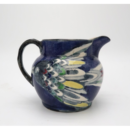 2187 - ELIZABETH MARY WATT (SCOTTISH 1886-1954)A bird painted jug with dark blue ground, signed EM Watt, 11... 