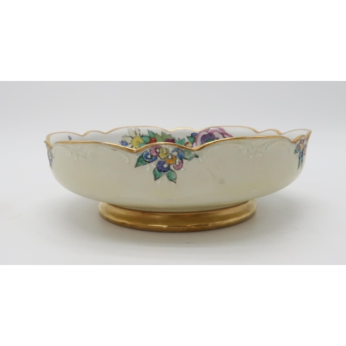 2192 - ELIZABETH MARY WATT (SCOTTISH 1886-1954)A large circular porcelain dish with wavy edge, painted with... 