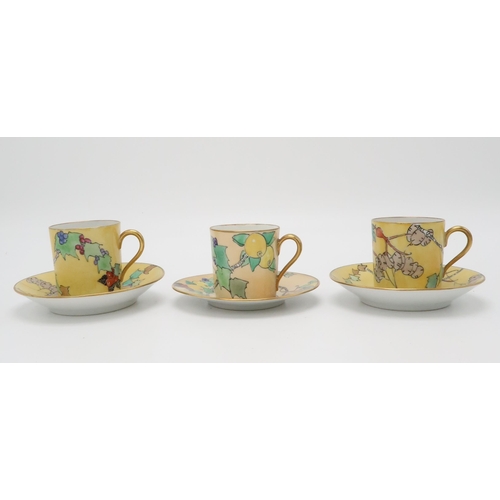 2193 - ELIZABETH MARY WATT (SCOTTISH 1886-1954)A pair of coffee cans and saucers, painted with honesty, ros... 