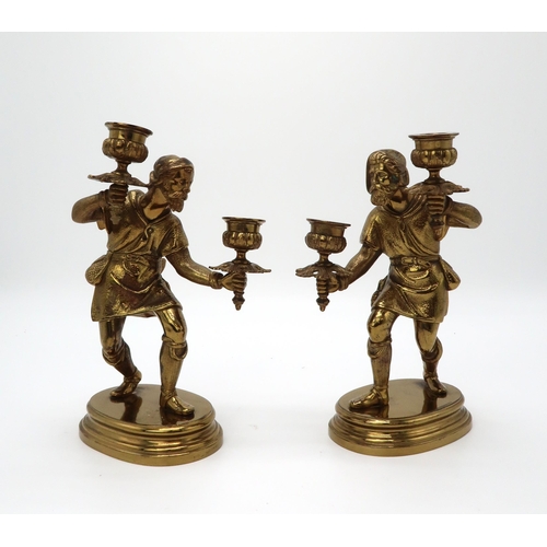 2207 - A PAIR OF GILT BRONZE FIGURAL CANDLESTICKSeach modelled as a man, upon oval socle bases, 24.5cm high... 