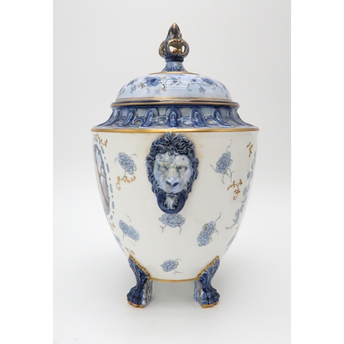 2209 - A ROYAL CROWN DERBY URN AND COVERthe body with lion's head masks and upon four paw feet, the white a... 