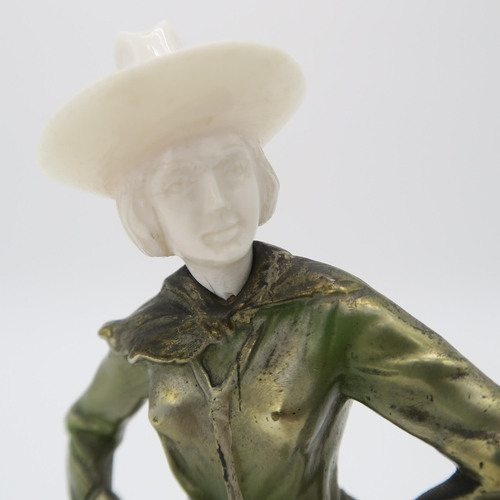 2220 - A PATINATED BRONZE AND IVORY ART DECO FIGURE OF A COWGIRLpossibly by Joseph Lorenzl, standing with h... 