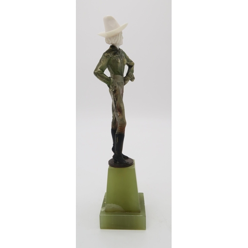 2220 - A PATINATED BRONZE AND IVORY ART DECO FIGURE OF A COWGIRLpossibly by Joseph Lorenzl, standing with h... 