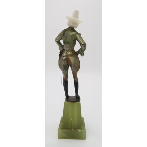 2220 - A PATINATED BRONZE AND IVORY ART DECO FIGURE OF A COWGIRLpossibly by Joseph Lorenzl, standing with h... 