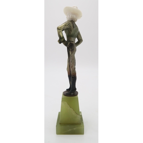 2220 - A PATINATED BRONZE AND IVORY ART DECO FIGURE OF A COWGIRLpossibly by Joseph Lorenzl, standing with h... 