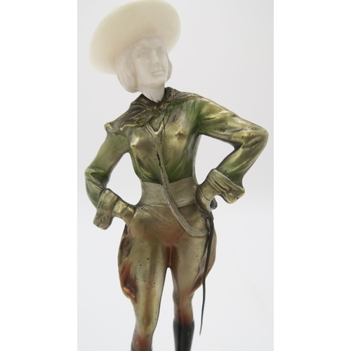 2220 - A PATINATED BRONZE AND IVORY ART DECO FIGURE OF A COWGIRLpossibly by Joseph Lorenzl, standing with h... 