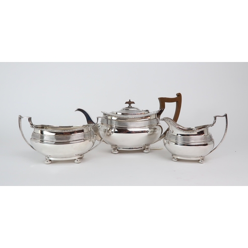 2452 - AN EDWARDIAN THREE PIECE SILVER TEA SERVICEby James Deakin & Sons, Sheffield 1912, of squat form... 