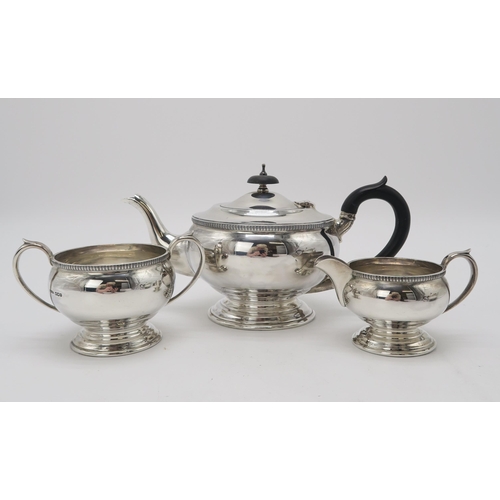 2485 - A GEORGE VI THREE PIECE SILVER TEA SERVICEby Fenton Brothers, Sheffield 1945, of globular form, with... 