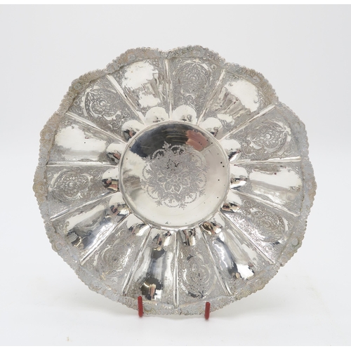 2488 - A PERSIAN SILVER FOOTED DISHof lobed form, the well decorated with a central floral medallion, the b... 