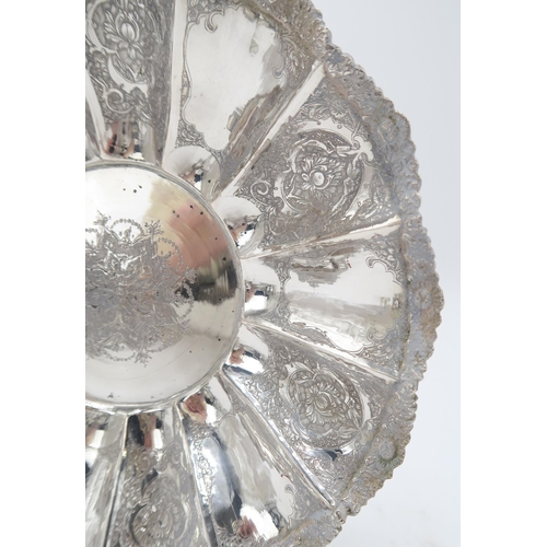 2488 - A PERSIAN SILVER FOOTED DISHof lobed form, the well decorated with a central floral medallion, the b... 